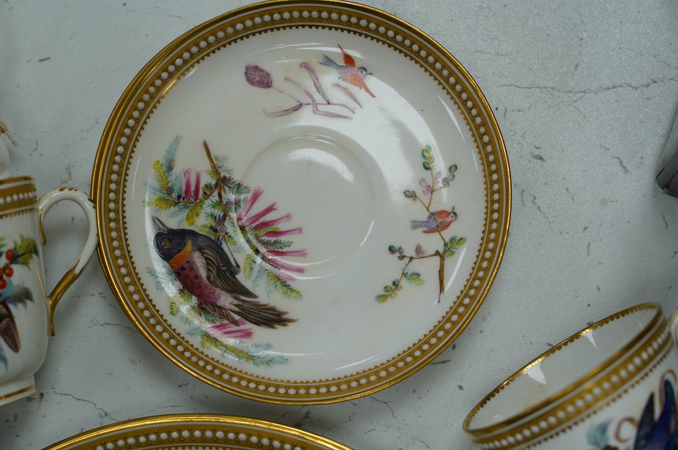 A 19th century Royal Worcester ornithologically decorated part tea set, with gilt and jewelled edges, six place setting. Condition - good